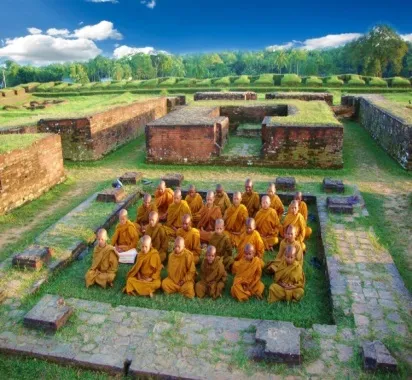 Novices meditating among the brick ruins of an ancient monastery