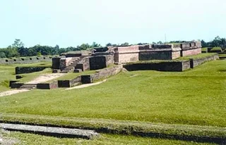 Excavated brick walls of Salban Vihara on a grassy site