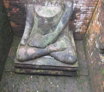Seated Buddha statue in place at Itakhola Mura, its head now missing