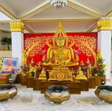 Golden Buddha image on an ornate red and gold altar