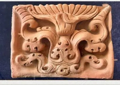Terracotta plaque decorated with scrolling foliage